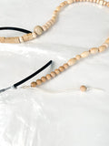 Close-up of reprocessed wooden beads on a handmade glasses chain