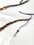 Close-up of reprocessed wooden beads on a handmade glasses chain
