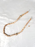 Reprocessed wooden bead glasses chain shown laid flat, highlighting bead pattern and colour