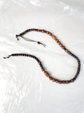 Reprocessed wooden bead glasses chain shown laid flat, highlighting bead pattern and colour