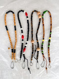 A selection of different handmade beaded crossbody keyring with reclaimed wooden beads and metal carabiner