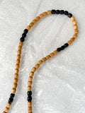 Close-up of reprocessed wooden beads on handmade crossbody keyring showing natural colour variations