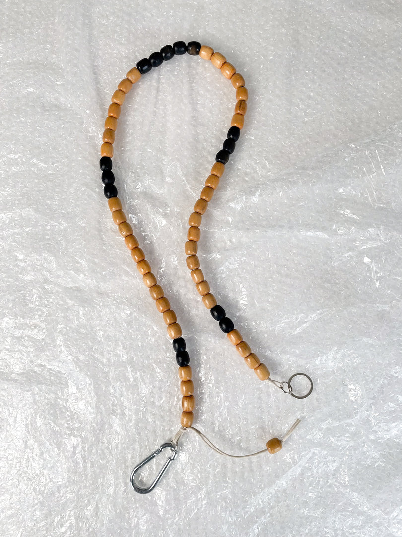 Handmade beaded crossbody keyring with natural and black reclaimed wooden beads and metal carabiner