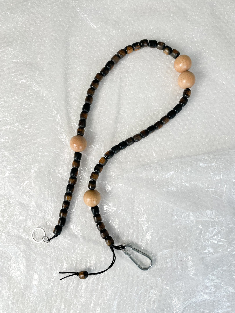 Handmade beaded crossbody keyring with charcoal and natural reclaimed wooden beads and metal carabiner
