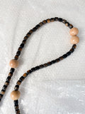 Close-up of reprocessed wooden beads on handmade crossbody keyring showing natural colour variations