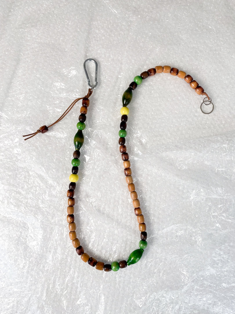 Handmade beaded crossbody keyring with brown and green reclaimed wooden beads and metal carabiner