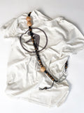 Earthy tones handmade beaded crossbody keyring worn on a t-shirt, made from reclaimed wood and cotton cord