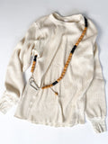 Colourful handmade beaded crossbody keyring worn on a t-shirt, made from reclaimed wood and cotton cord