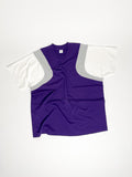 Upcycled panel T-shirt in purple, grey and white, made from second-hand T-shirts and deadstock jersey. Flat lay on white background.