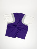 Upcycled panel T-shirt in purple, grey and white, made from second-hand T-shirts and deadstock jersey. Flat lay on white background.