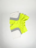 Upcycled panel T-shirt in neon yellow, grey and white, made from second-hand T-shirts and deadstock jersey. Flat lay on white background.