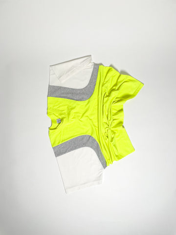 Upcycled panel T-shirt in neon yellow, grey and white, made from second-hand T-shirts and deadstock jersey. Flat lay on white background.
