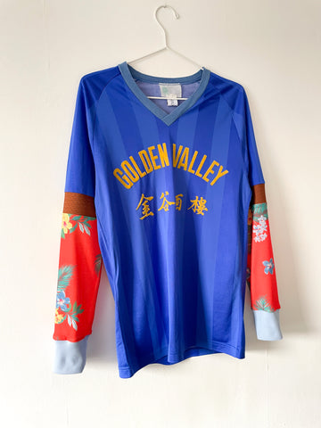 Blue and orange long sleeve football jersey on a white background