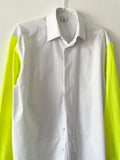 Detail of a Pleated white shirt with neon yellow T-shirt sleeves on a white background 