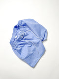 Light blue chambray boxer shorts with a board shorts-inspired design, featuring an elastic waistband, white drawstring, and relaxed fit.