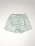 Green and purple Teddy bear print cotton boxer shorts with a board shorts-inspired design, featuring an elastic waistband, white drawstring, and relaxed fit.