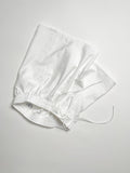 White cotton boxer shorts with a board shorts-inspired design, featuring an elastic waistband, white drawstring, and relaxed fit.