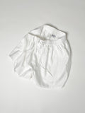 White cotton boxer shorts with a board shorts-inspired design, featuring an elastic waistband, white drawstring, and relaxed fit.